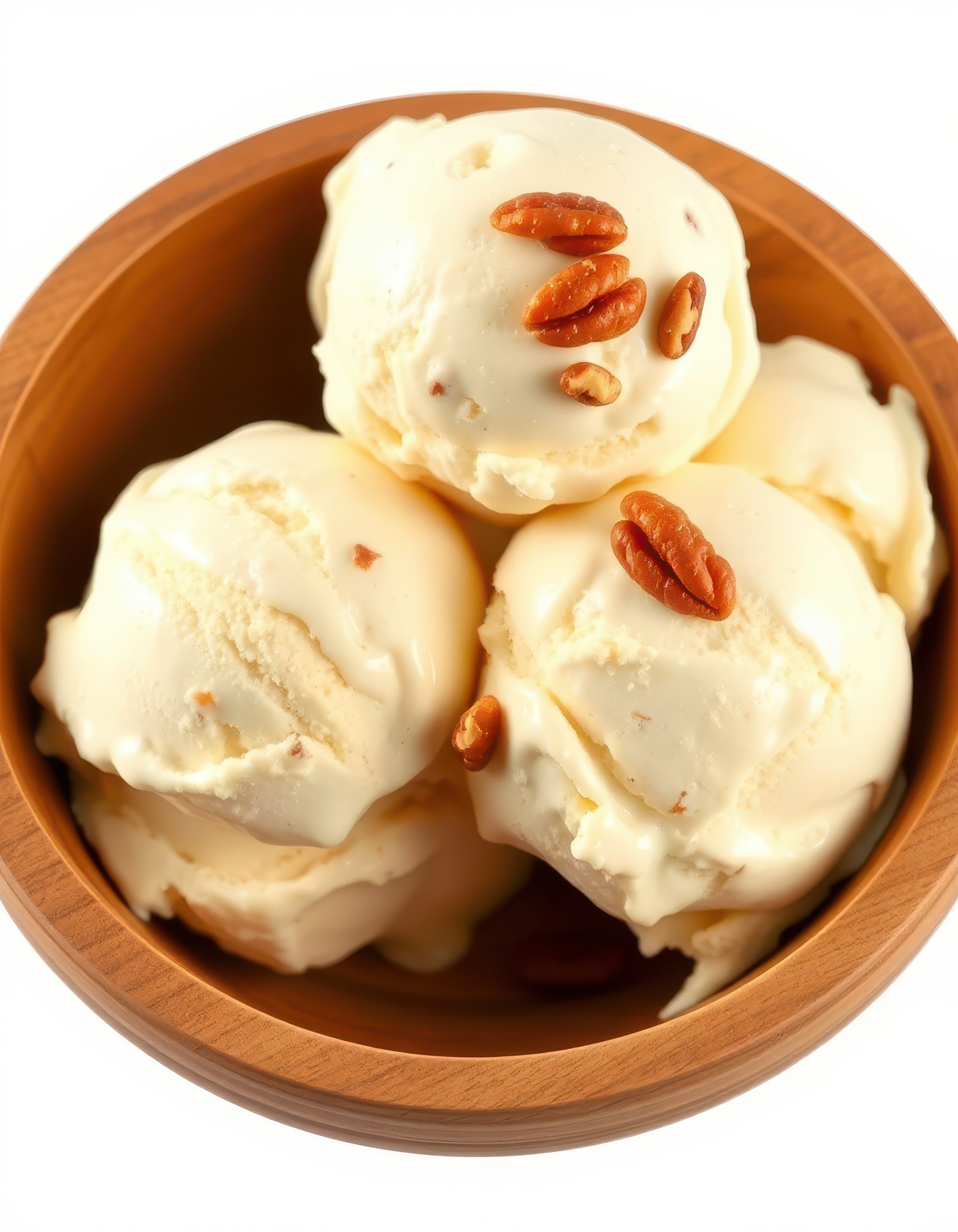 Creamy vanilla ice cream scoops served in a wooden bowl with crunchy nuts on top